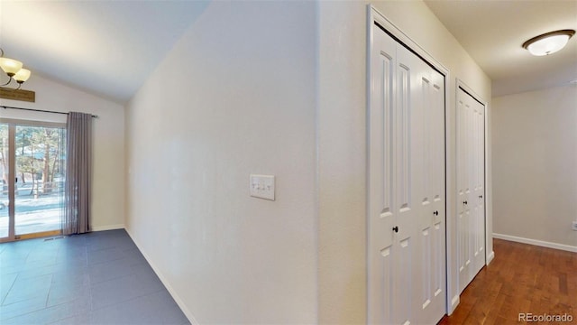 hallway featuring lofted ceiling