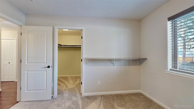 walk in closet featuring light carpet