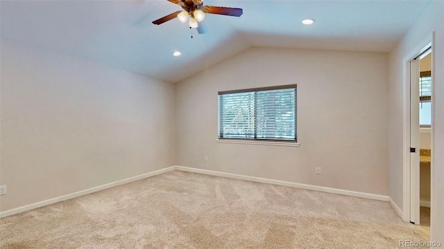 unfurnished room with light carpet, vaulted ceiling, and ceiling fan