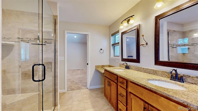 bathroom with tile patterned flooring, vanity, and an enclosed shower