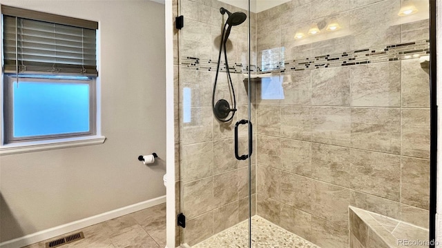 bathroom featuring a shower with shower door