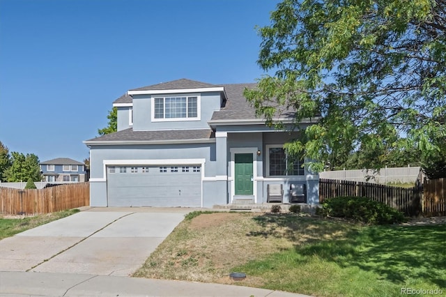 view of front of house featuring a garage and a front yard