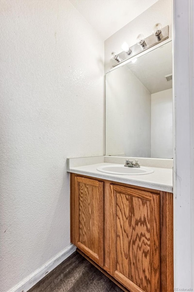 bathroom with vanity and wood-type flooring