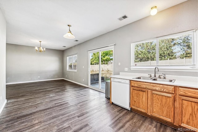 kitchen with sink, an inviting chandelier, dark hardwood / wood-style floors, white dishwasher, and pendant lighting