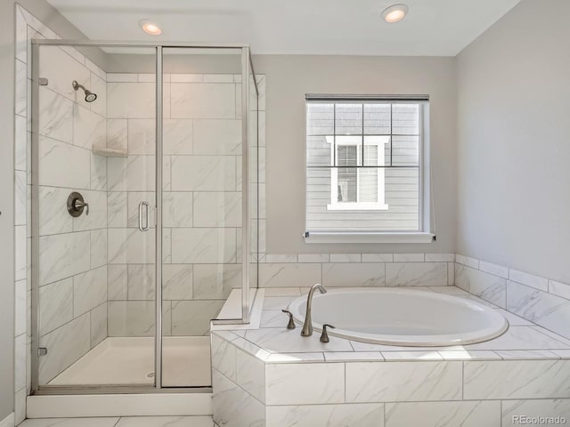 full bathroom featuring a stall shower and a garden tub