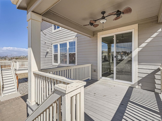 deck featuring ceiling fan and stairway