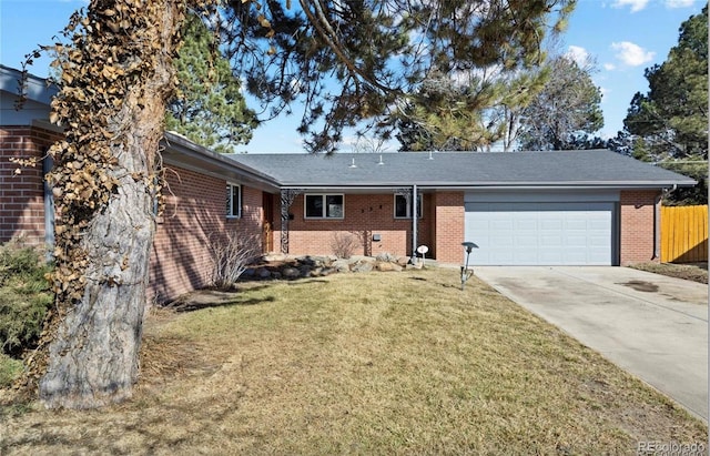 single story home with a front yard and a garage