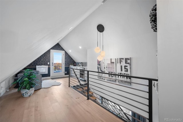 interior space featuring vaulted ceiling and wood finished floors