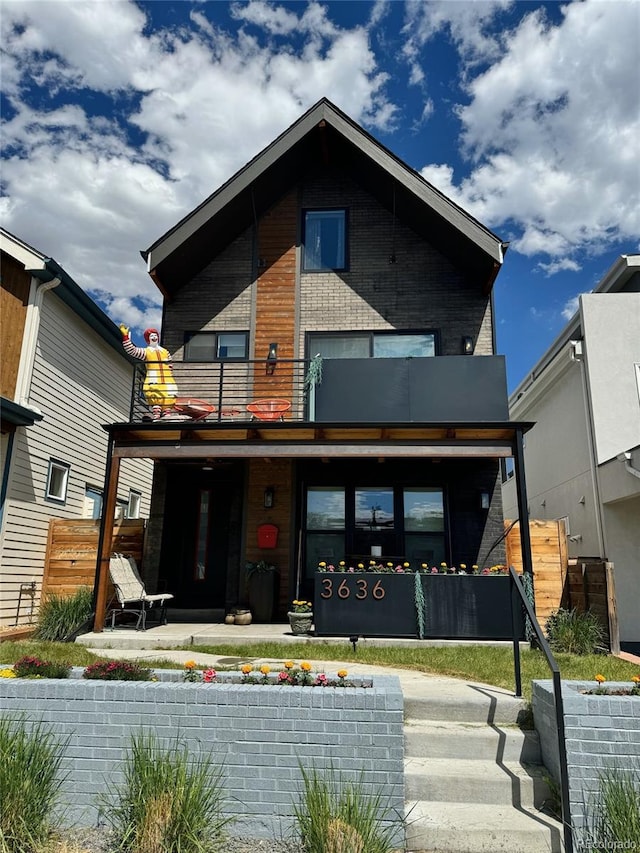 back of property featuring fence and a balcony