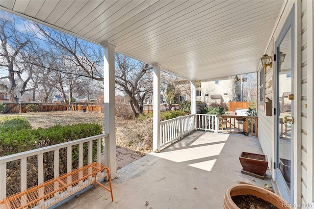 view of patio / terrace featuring a porch and fence