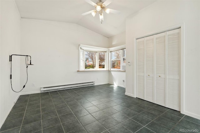 unfurnished bedroom featuring dark tile patterned flooring, a closet, baseboards, baseboard heating, and vaulted ceiling