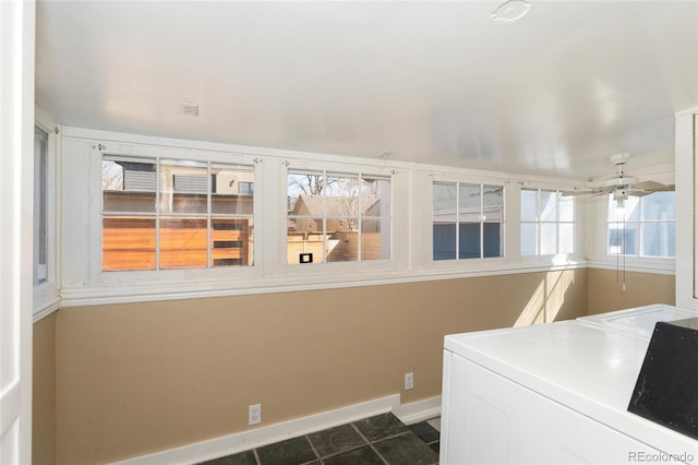 interior space with washer and clothes dryer, laundry area, ceiling fan, and baseboards