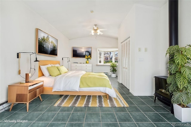 tiled bedroom featuring a closet and lofted ceiling