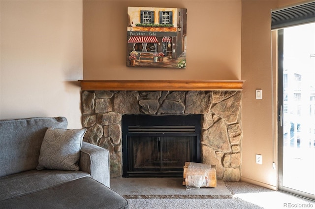 room details featuring carpet and a stone fireplace