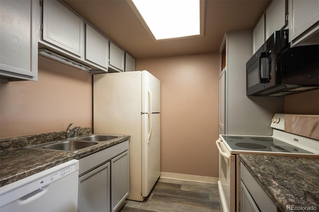 kitchen featuring gray cabinetry, white appliances, dark wood-type flooring, and sink