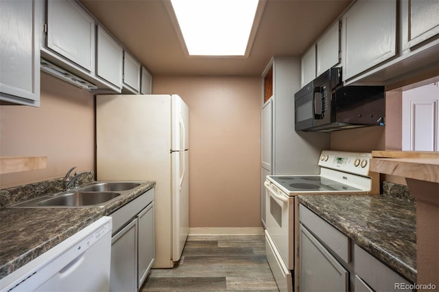 kitchen featuring gray cabinetry, dark hardwood / wood-style floors, white appliances, and sink