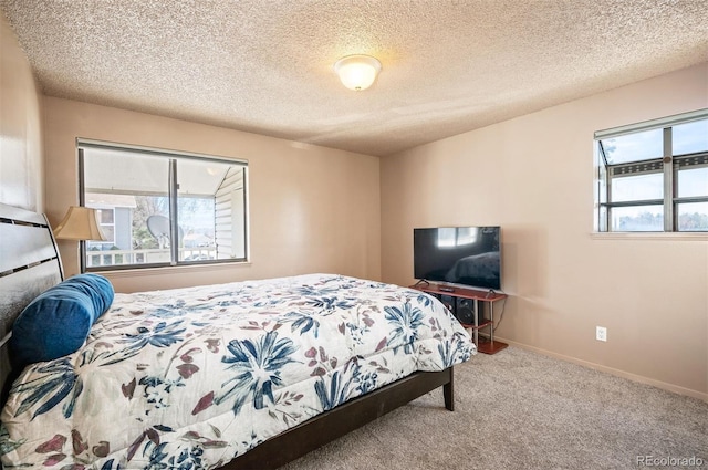 carpeted bedroom featuring a textured ceiling