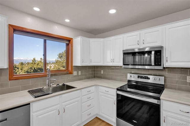 820 Schulze Ranch Rd, Westcliffe, CO 81252 - kitchen with appliances with stainless steel finishes, a sink, light countertops, tasteful backsplash, and recessed lighting