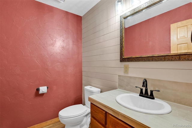 820 Schulze Ranch Rd, Westcliffe, CO 81252 - half bathroom with toilet, vanity, and wooden walls