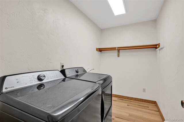 820 Schulze Ranch Rd, Westcliffe, CO 81252 - washroom featuring separate washer and dryer, wood finished floors, and baseboards