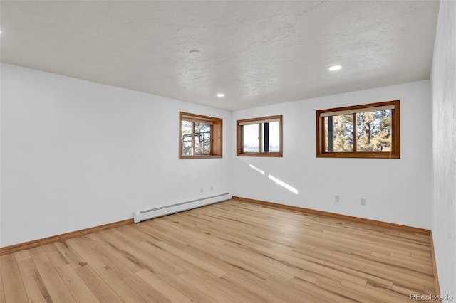 820 Schulze Ranch Rd, Westcliffe, CO 81252 - empty room featuring baseboard heating, light wood-type flooring, baseboards, and recessed lighting