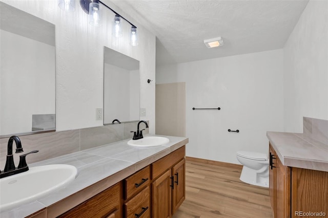 820 Schulze Ranch Rd, Westcliffe, CO 81252 - full bathroom featuring wood finished floors, toilet, double vanity, and baseboards