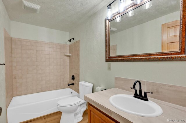 820 Schulze Ranch Rd, Westcliffe, CO 81252 - bathroom with a textured ceiling, bathtub / shower combination, toilet, a textured wall, and wood finished floors