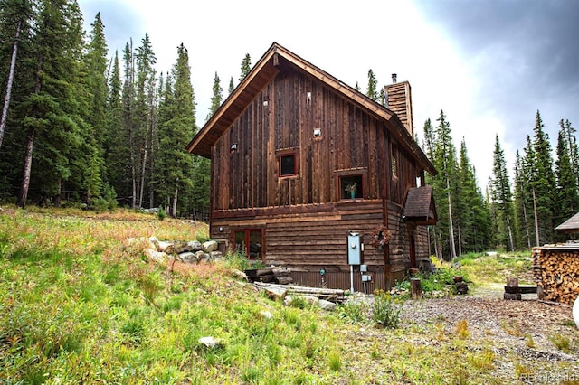 10 Bullion Mine Rd, Keystone, CO 80435 - view of side of home featuring a chimney and a view of trees