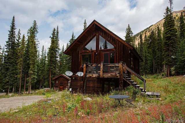10 Bullion Mine Rd, Keystone, CO 80435 - view of front of house featuring stairs, a view of trees, and a wooden deck