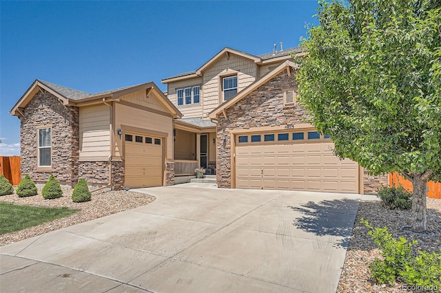 5923 S Jamestown Ct, Aurora, CO 80016 - craftsman house with stone siding, an attached garage, and driveway