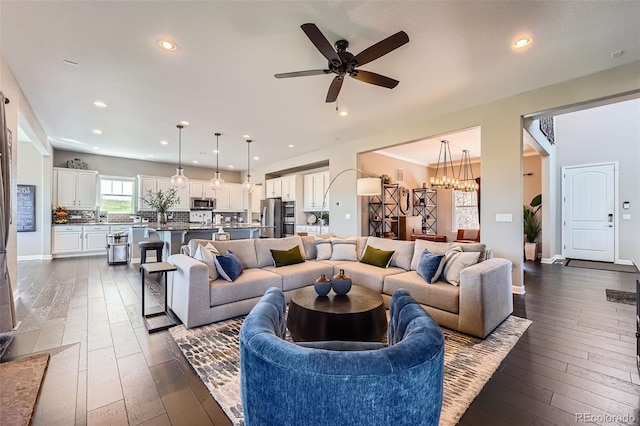 5923 S Jamestown Ct, Aurora, CO 80016 - living area featuring dark wood finished floors, ceiling fan, recessed lighting, and a chandelier