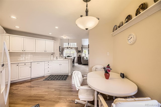 2700 W Riverwalk Cir Unit C, Littleton, CO 80123 - kitchen with dishwasher, recessed lighting, a chandelier, white cabinetry, and light wood-style floors