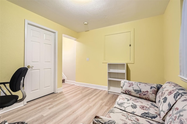 2700 W Riverwalk Cir Unit C, Littleton, CO 80123 - home office with light wood-type flooring, baseboards, and a textured ceiling