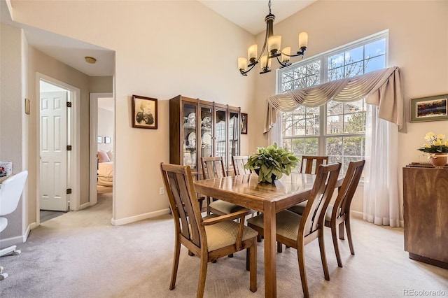 2700 W Riverwalk Cir Unit C, Littleton, CO 80123 - dining area featuring a chandelier, light carpet, and a high ceiling