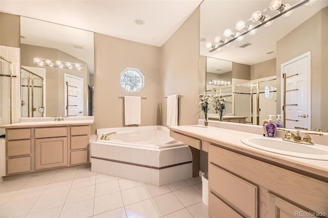 2700 W Riverwalk Cir Unit C, Littleton, CO 80123 - full bathroom featuring a stall shower, a garden tub, tile patterned flooring, and two vanities
