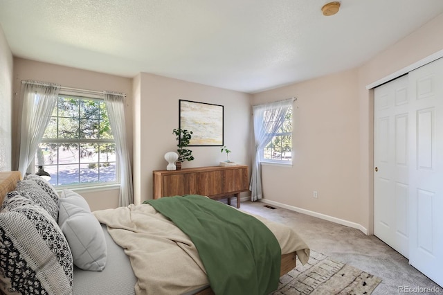 2700 W Riverwalk Cir Unit C, Littleton, CO 80123 - bedroom featuring light carpet and baseboards