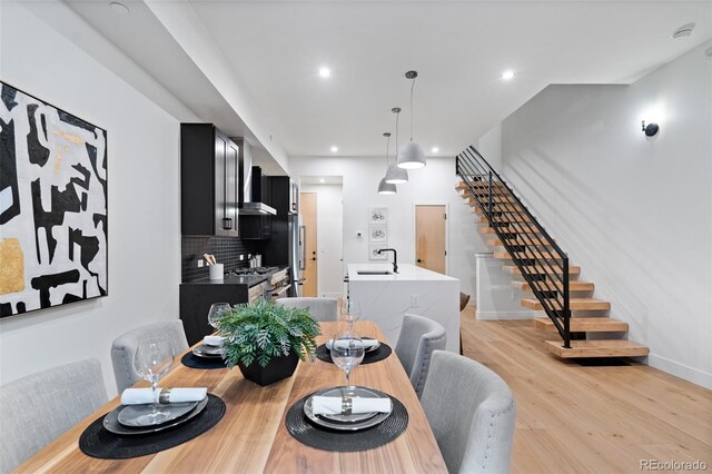 dining space featuring sink and light hardwood / wood-style floors