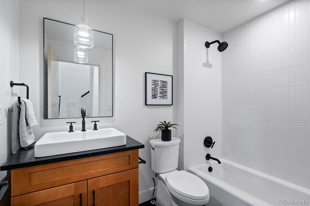 full bathroom featuring vanity, toilet, and tiled shower / bath combo