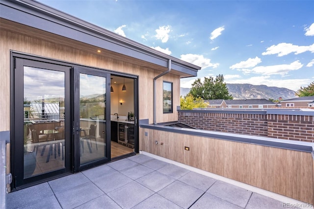 view of patio / terrace with a mountain view and a balcony