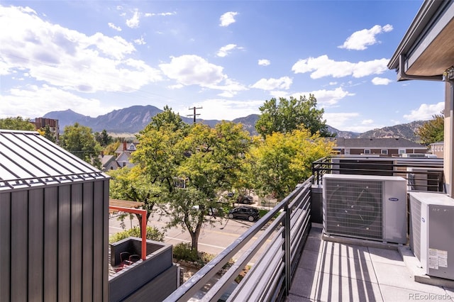 balcony featuring central AC unit and a mountain view