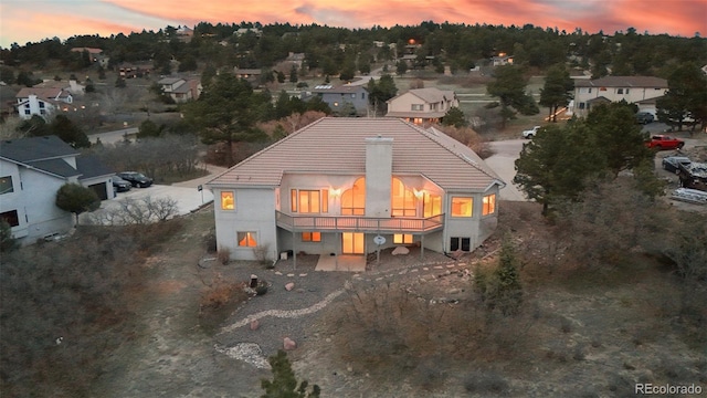 265 Ox Yoke Way, Monument, CO 80132 - back of property at dusk with a tiled roof