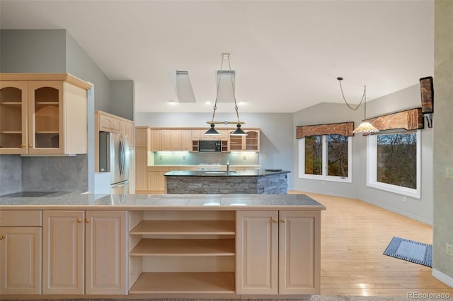 265 Ox Yoke Way, Monument, CO 80132 - kitchen featuring open shelves, freestanding refrigerator, black microwave, backsplash, and glass insert cabinets