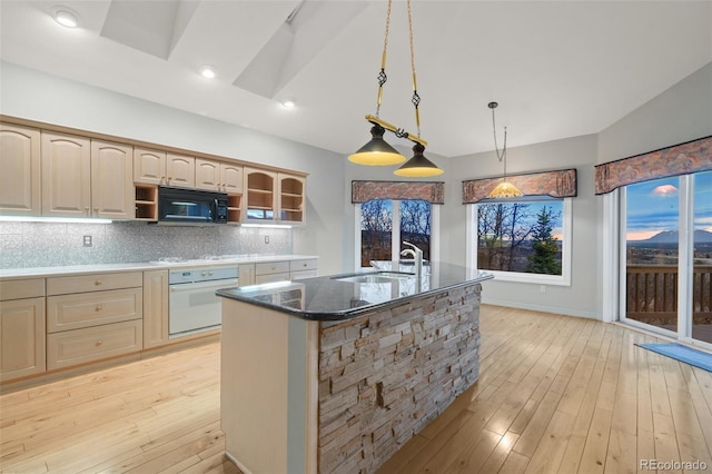265 Ox Yoke Way, Monument, CO 80132 - kitchen with white oven, a sink, black microwave, open shelves, and backsplash
