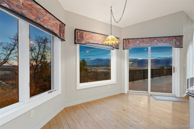 265 Ox Yoke Way, Monument, CO 80132 - unfurnished dining area featuring wood finished floors and baseboards