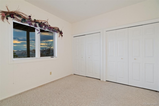 265 Ox Yoke Way, Monument, CO 80132 - unfurnished bedroom featuring multiple closets, carpet flooring, and baseboards