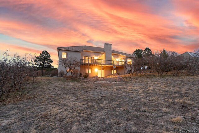 265 Ox Yoke Way, Monument, CO 80132 - back of house with a deck, a chimney, and stucco siding
