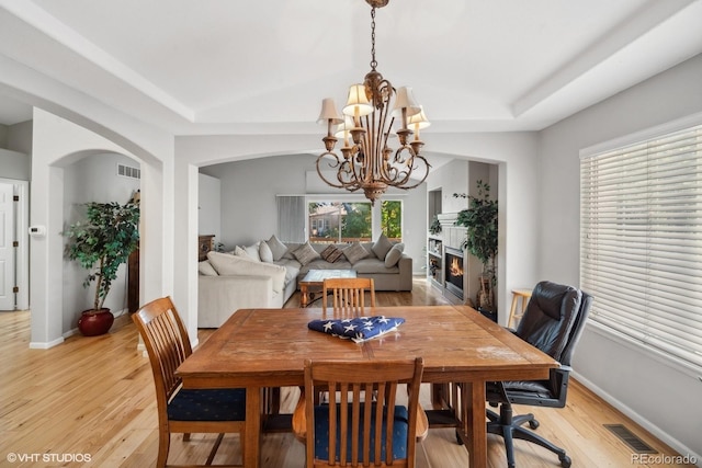 dining space with a notable chandelier and light hardwood / wood-style flooring