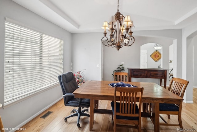 dining room featuring light hardwood / wood-style floors and a notable chandelier