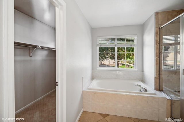 bathroom with independent shower and bath and tile patterned flooring