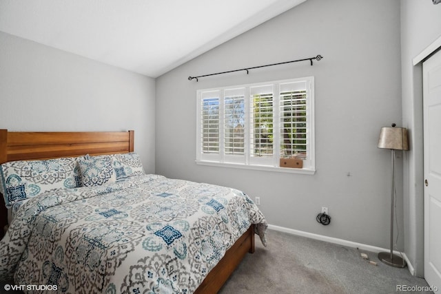 bedroom featuring lofted ceiling and light colored carpet